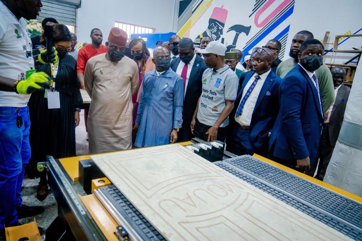 Officials touring a university incubation and manufacturing lab